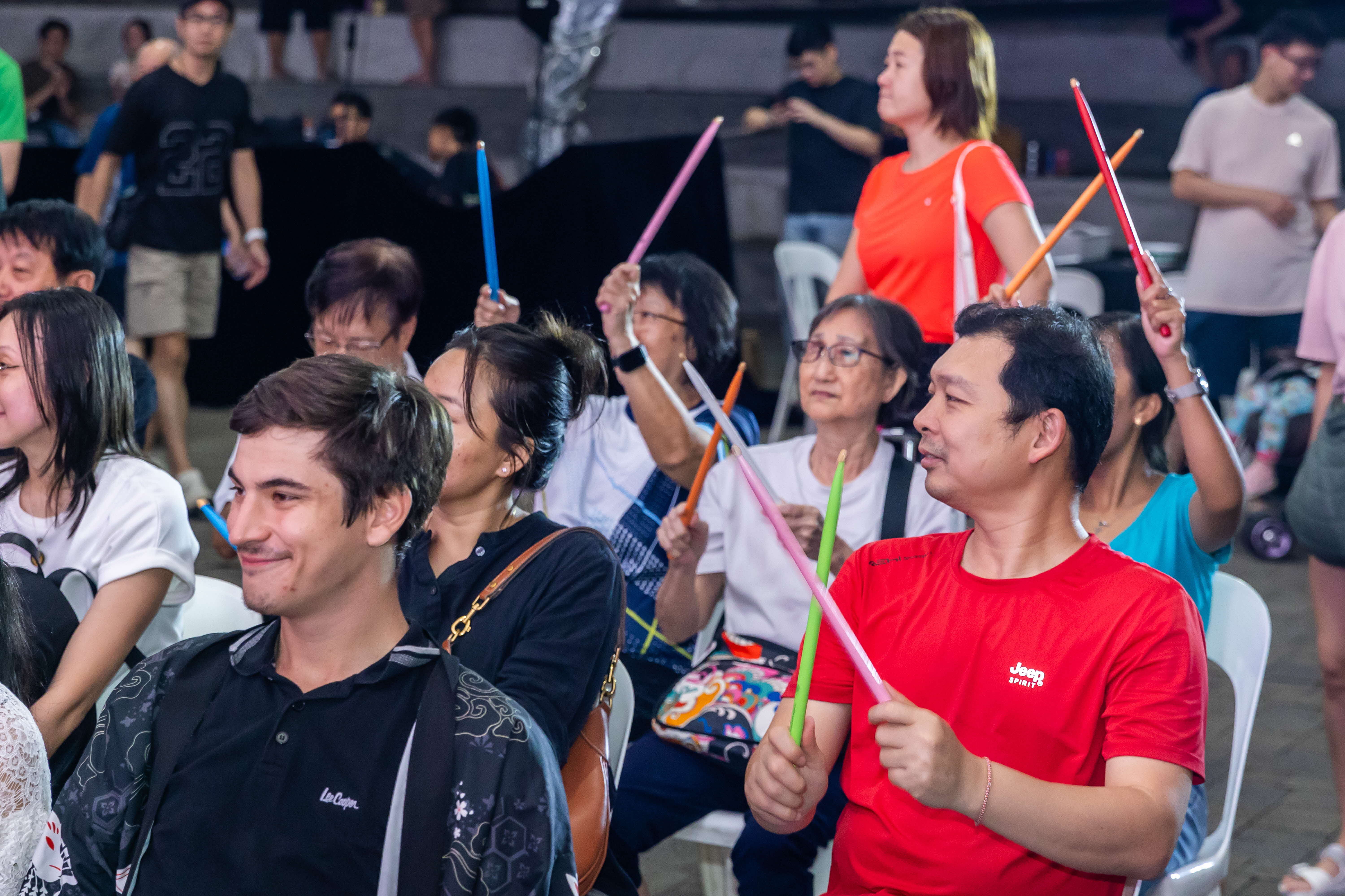 eventgoers holding drum sticks as part of a ArtsEverywhere @ CDC Performance